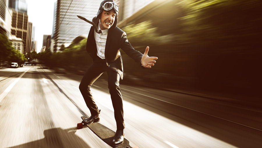 IMAGE-Businessman-on-speeding-skateboard-e1494464341221